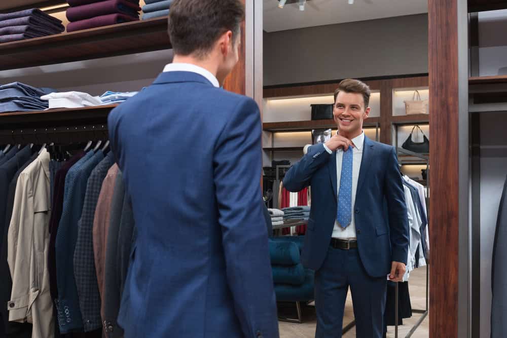 A man admires his new bespoke suit
