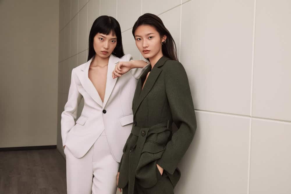 Two women in well-fitted suits