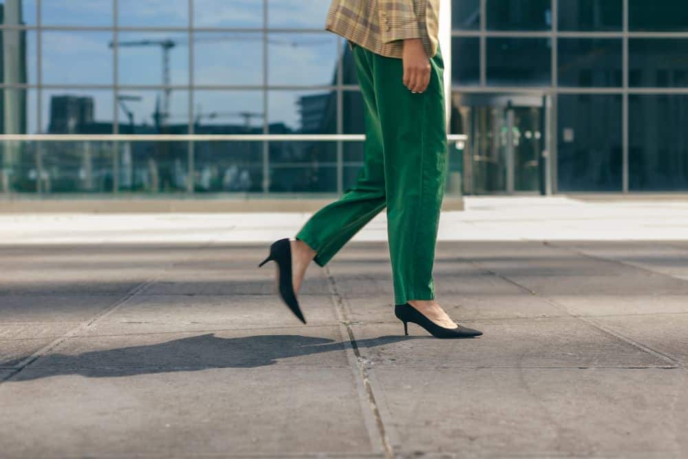 A woman in a suite walking in pointed-toe pumps