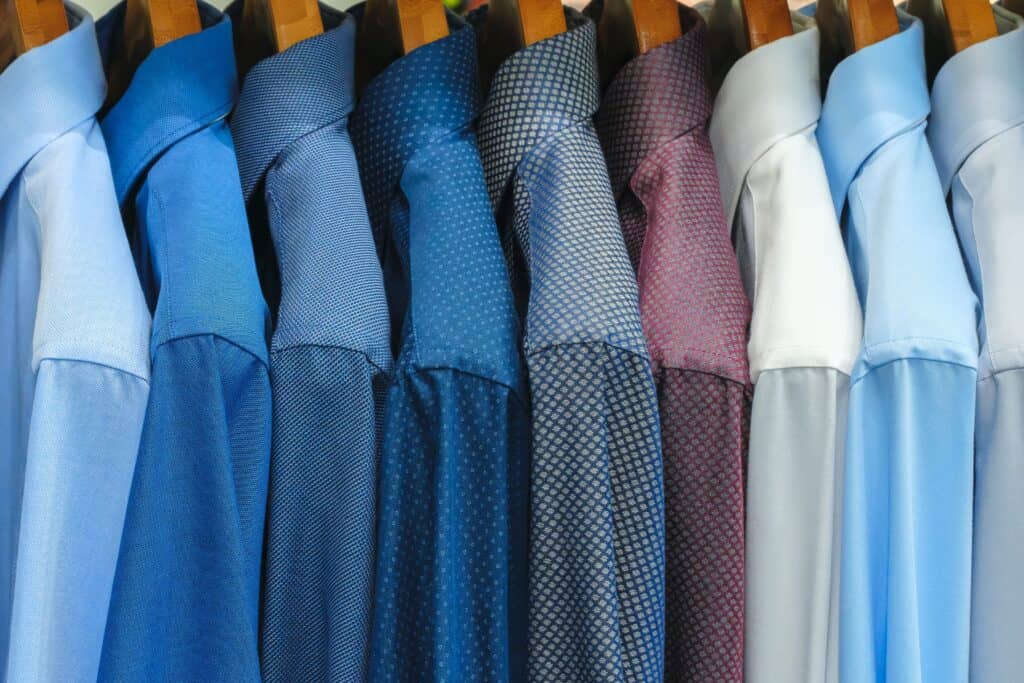 A row of tailored long-sleeved collared shirts