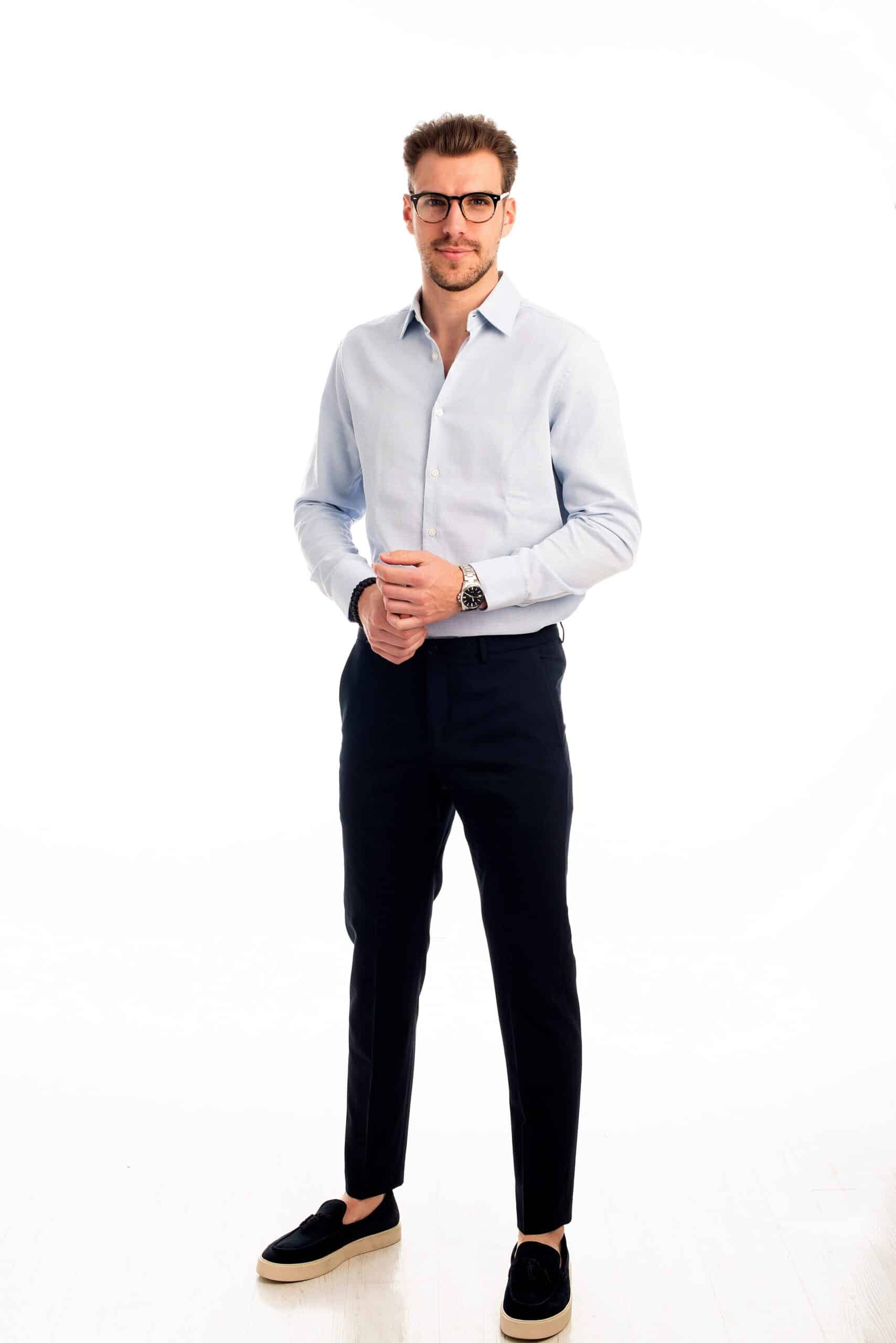 A man wearing a long-sleeved shirt and pants