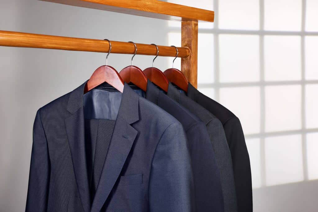 A rack with dark-colored business suits