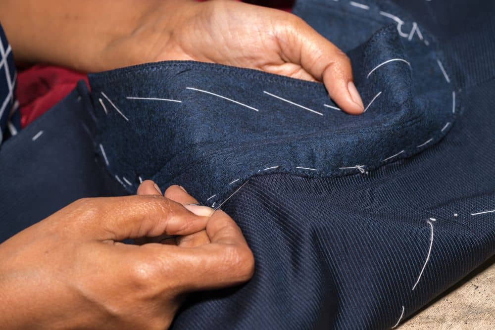 Close-up of suit construction showing the layer between the outer fabric and lining