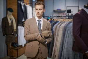 A man dressed in a well-fitting suit. A good fit is the foundation of how to look taller in a suit.