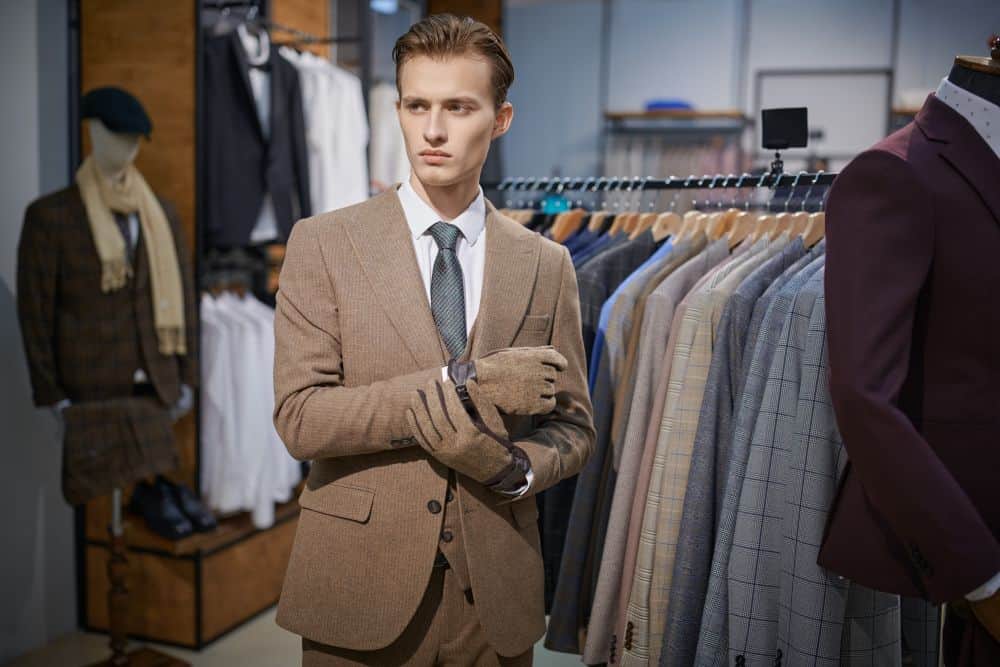 A man dressed in a well-fitting suit. A good fit is the foundation of how to look taller in a suit.