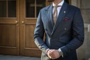 A man dressed in a well-tailored suit. A proper custom VBC fabric suit can work well in Bangkok.
