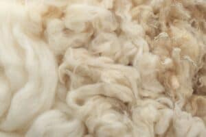 A close-up of wool fabric texture showing the fine fiber quality used in premium suit tailoring