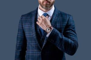 A businessman dressed in a suit. It doesn’t take much to know how to dress like a rich man.