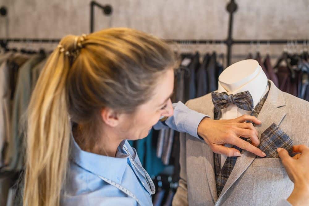 A three-point example of how to fold a pocket square inside a pinstripe suit jacket