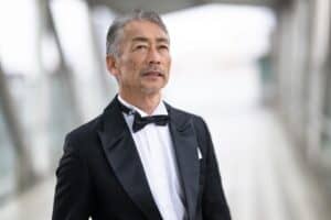 Man in a tuxedo with satin peak lapels and a black bow tie