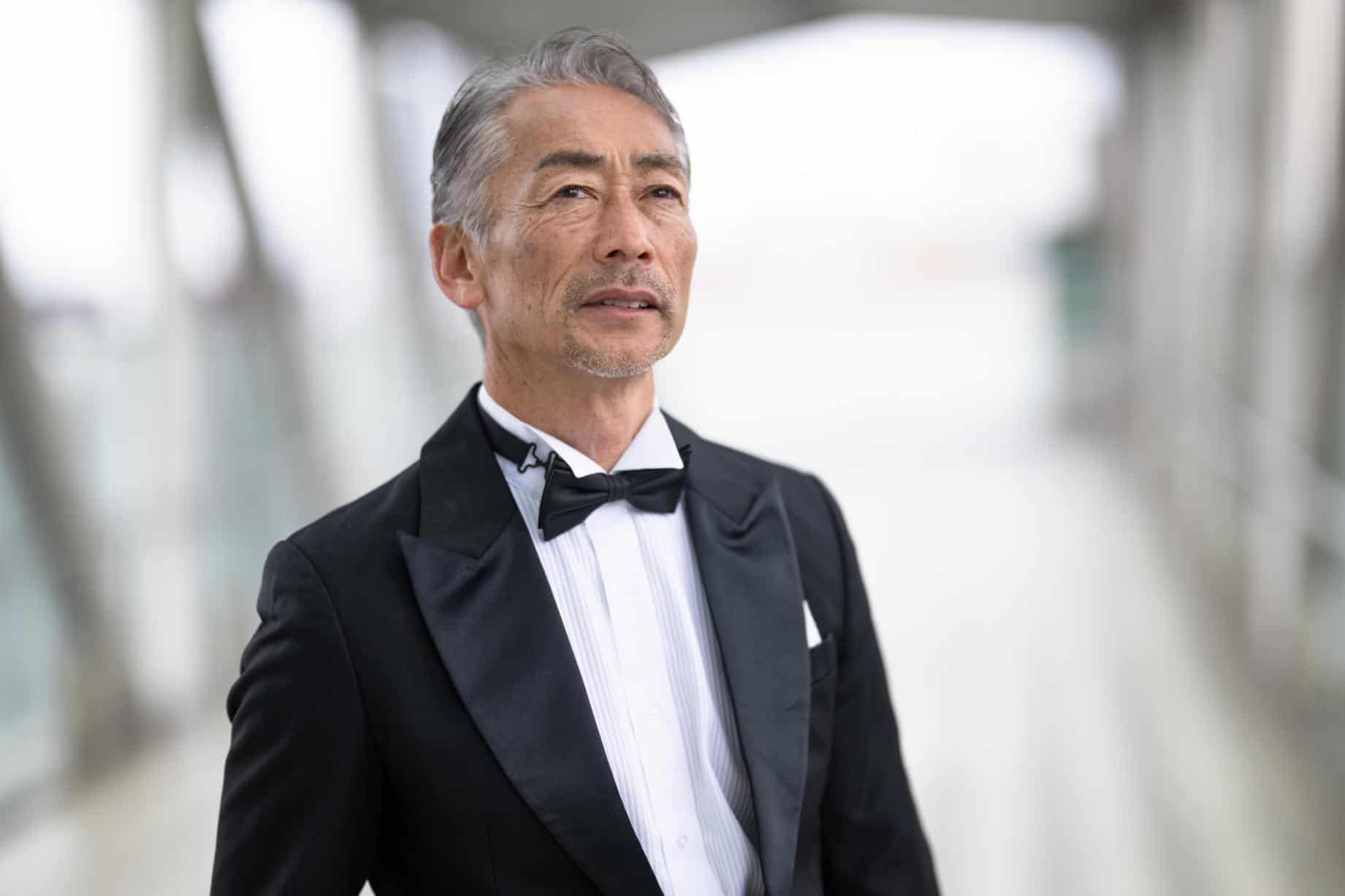 Man in a tuxedo with satin peak lapels and a black bow tie