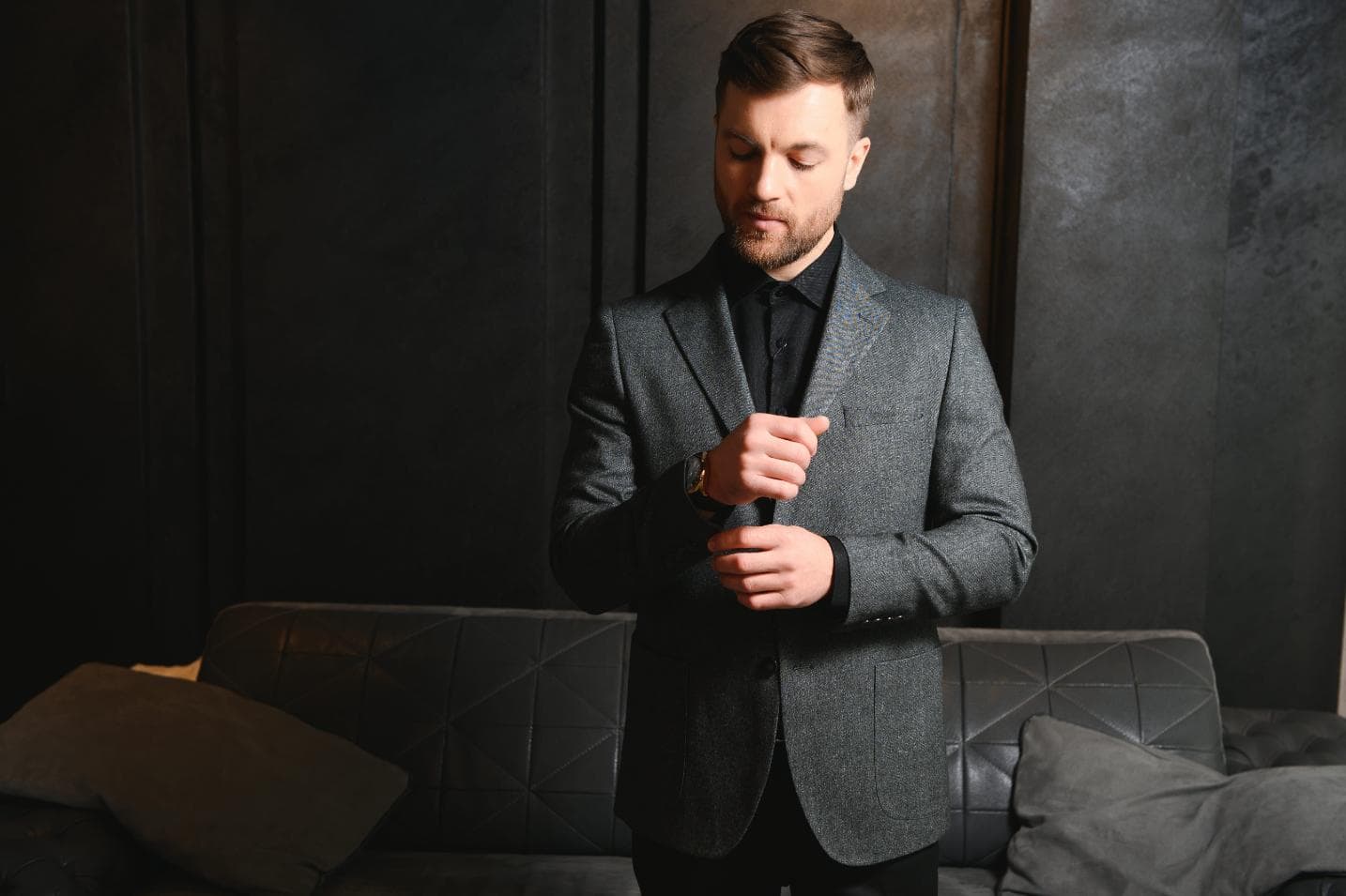 A man wearing a tailored cocktail attire outfit for an evening event.