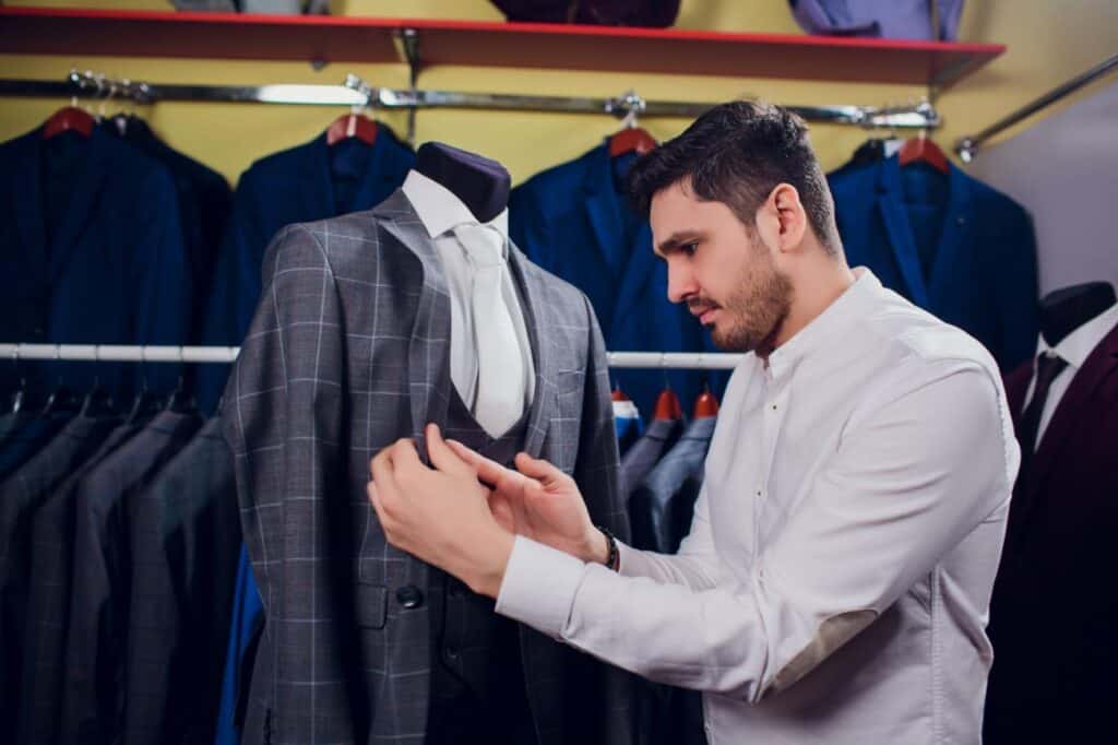 A tailor preparing to make suit alterations. How much to alter a suit depends on the scale of changes.