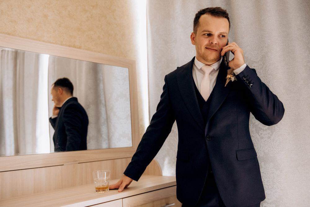 Groom wearing a three-piece suit with a light tie before the ceremony